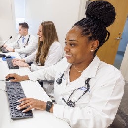 Photo of three resident working on computers in lab